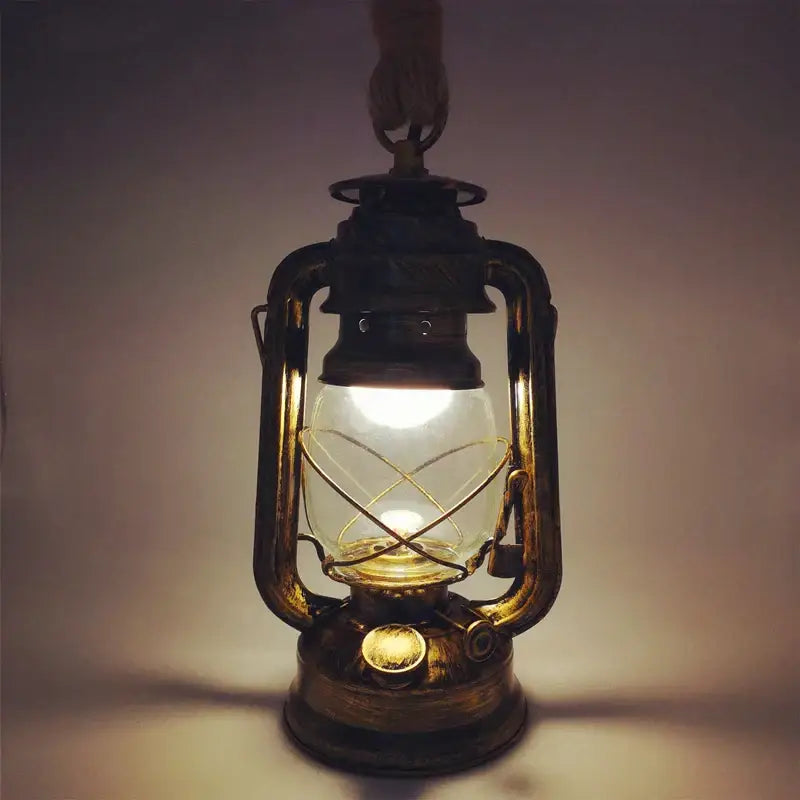 Vintage mixed metal cage pendant light with brass construction and clear glass globe providing decorative presence