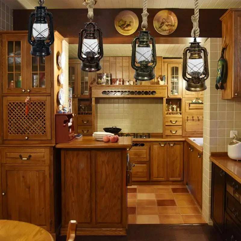 Four vintage-style black metal cage pendant lights hang above a wooden kitchen island providing decorative presence