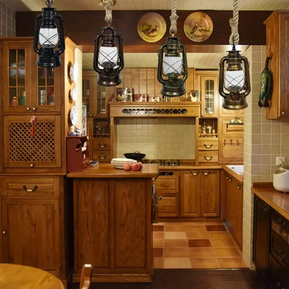 Four vintage-style black metal cage pendant lights hang above a wooden kitchen island providing decorative presence