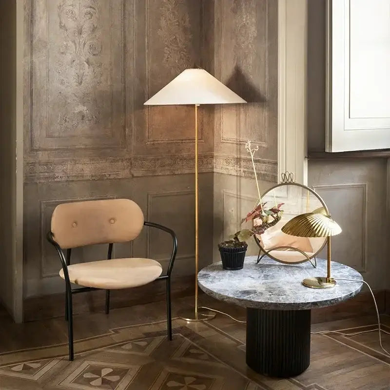 Gold-finished floor lamp with a conical off-white gubi rattan shade for vintage decorbites living room lighting