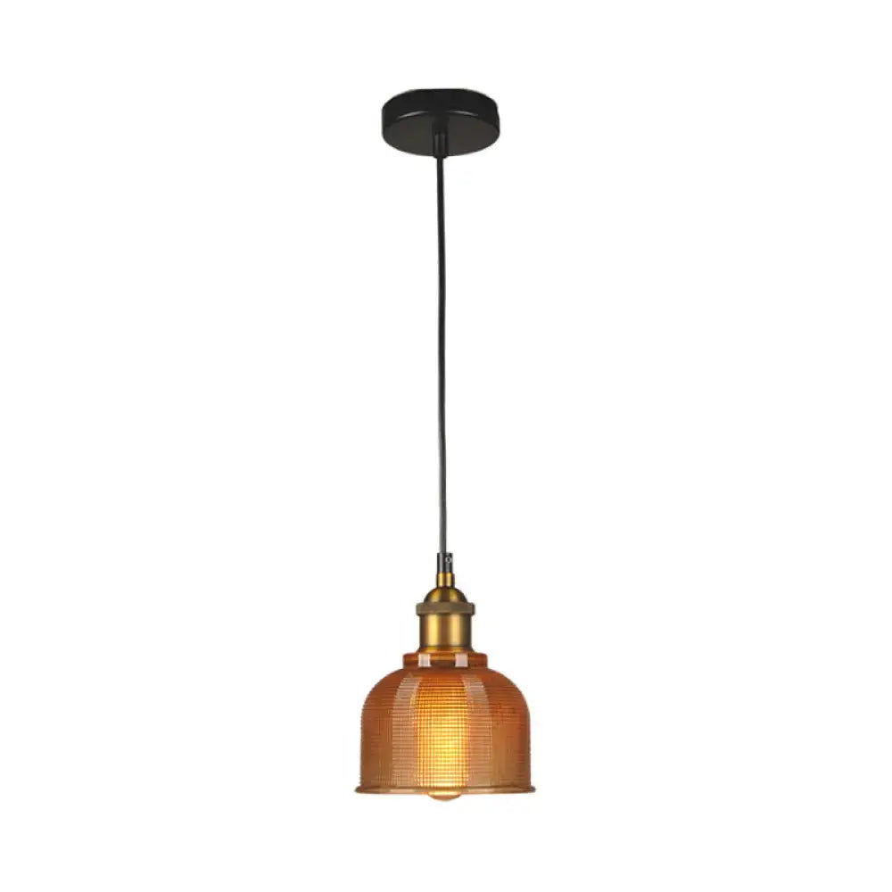 Warm amber glass DecorBites™ vintage carillon pendant light with brass fixture and black cord for dining room use