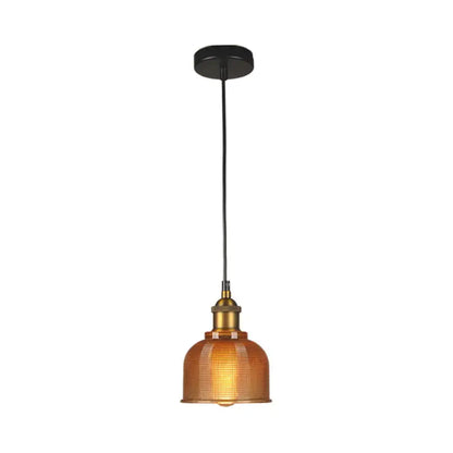 Warm amber glass DecorBites™ vintage carillon pendant light with brass fixture and black cord for dining room use