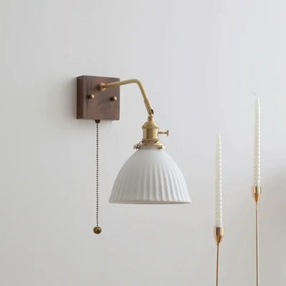 Vintage ribbed ceramic copper led wall lamp with white ribbed ceramic shade, brass arm, dark wood plate, and pull chain switch
