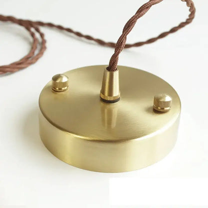 Brass-finished circular pendant light fixture with textured brown braided cord and adjustment knobs for kitchen use