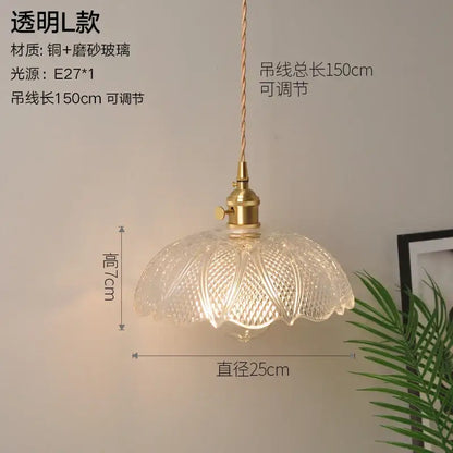 A clear vintage ribbed glass copper pendant light with brass fixture and adjustable cord for kitchen or dining room