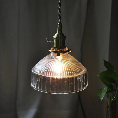 Vintage clear ribbed glass pendant light with dark green metal fixture and copper accents for dining room use