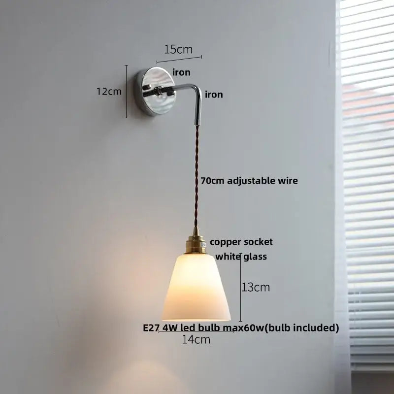 A sleek wall lamp with a polished iron bracket, adjustable wire, white ribbed opal glass shade, and decorbites ceramic canopy led