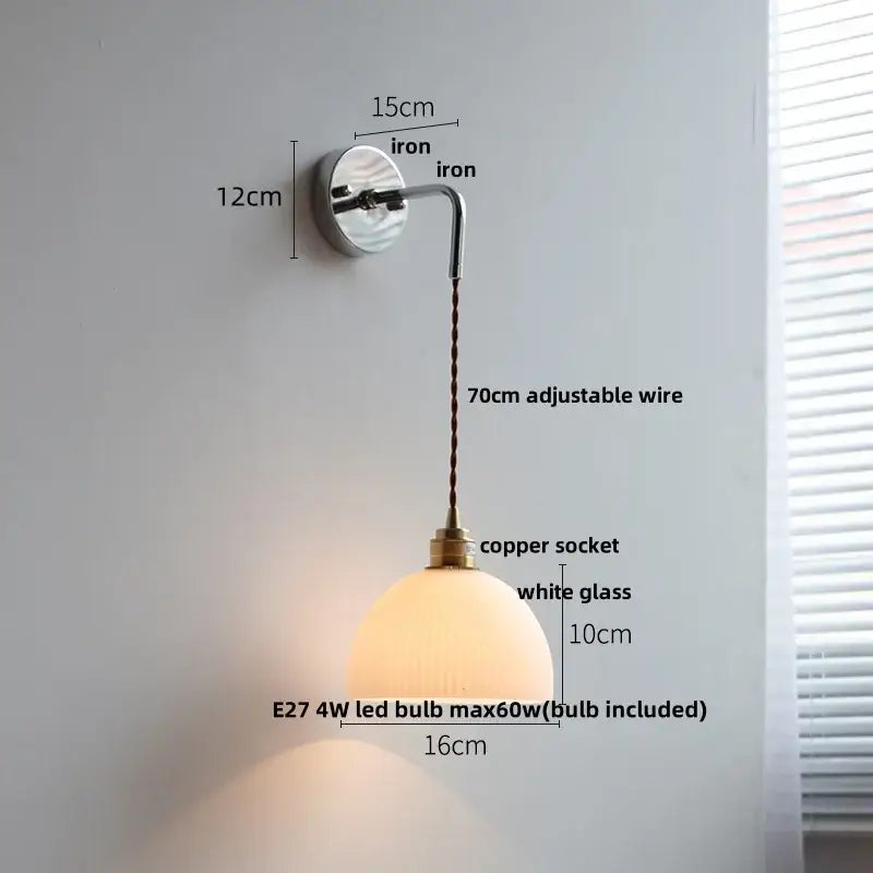 A warm white ribbed opal glass wall lamp with a polished brass socket and iron arm featuring decorbites ceramic canopy led