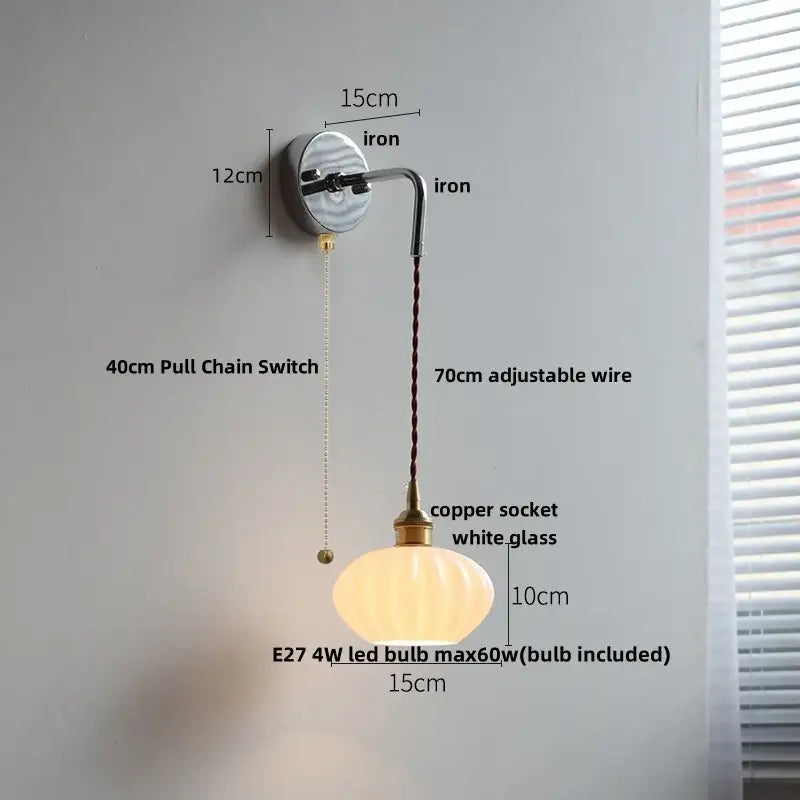 A warm white ribbed opal glass wall lamp with brass accents and decorbites ceramic canopy led for bedroom decor