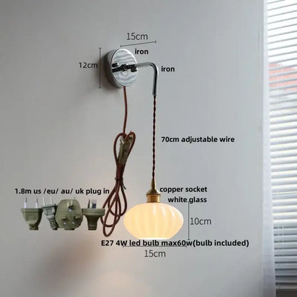 A warm glowing vintage ribbed white opal glass wall lamp with brass metal decorbites ceramic canopy led fitting