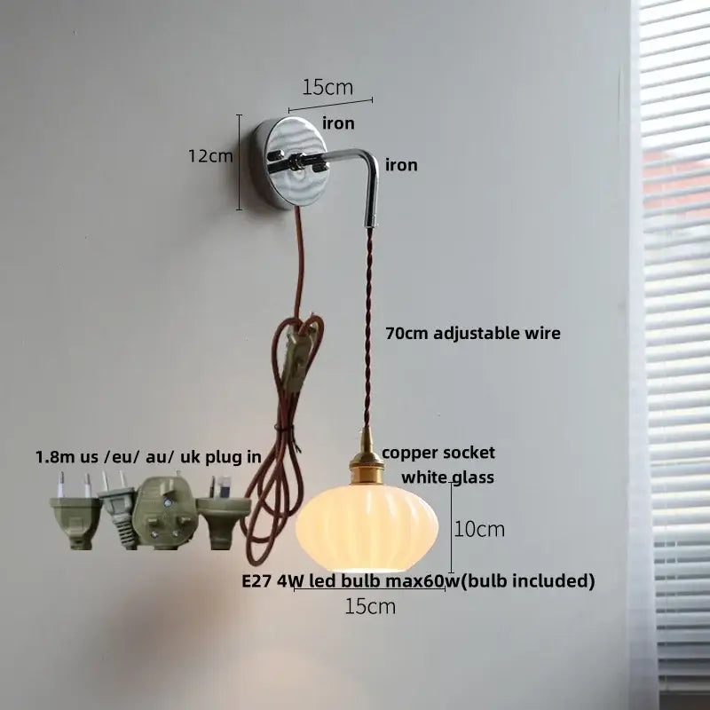 A warm glowing vintage ribbed white opal glass wall lamp with brass metal decorbites ceramic canopy led fitting