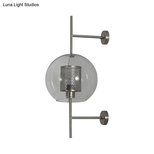 Modern vintage silver and gold clear glass sconce light with perforated metal shade and brushed nickel arms for bedroom walls