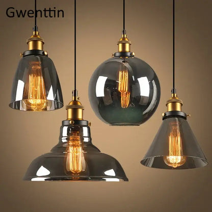Set of four vintage smoked glass and brass industrial glass pendant lights with exposed filament bulbs for kitchen decor