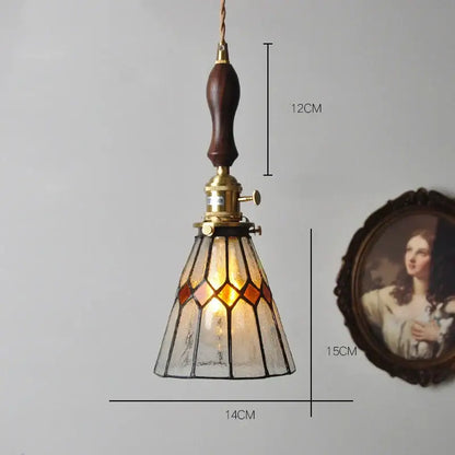 Vintage stained glass copper pendant light with amber and clear panels, dark wood knob switch, and brass hardware