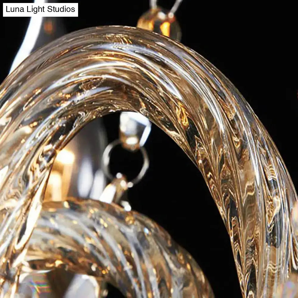 A vintage style amber crystal candle wall light component with clear twisted glass and a reflective golden hue