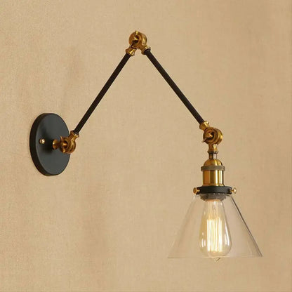Vintage style decorbites wall sconce with satin brass hardware black articulated arms and clear glass shade with filament bulb
