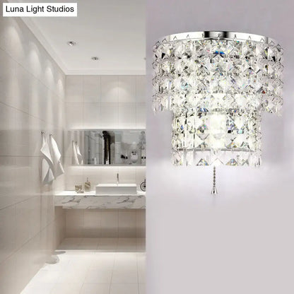 Vintage style wall sconce with sleek chrome frame and cascading clear crystal tiers for elegant bedroom lighting