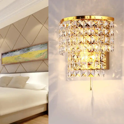 Vintage style wall sconce gold finished with cascading clear faceted crystal tiers for bedroom lighting