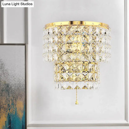Vintage style gold finished crystal wall sconce with tiered faceted glass and matching pull chain for bedroom lighting