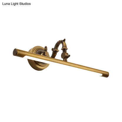 Antique brass-finished vintage style wall light with ornate scrollwork and tubular LED lamp for bathroom vanity use