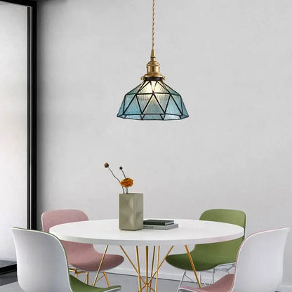 Vintage teal blue glass led pendant light with a brass finish hanging from a twisted cord for decorbites blue glass