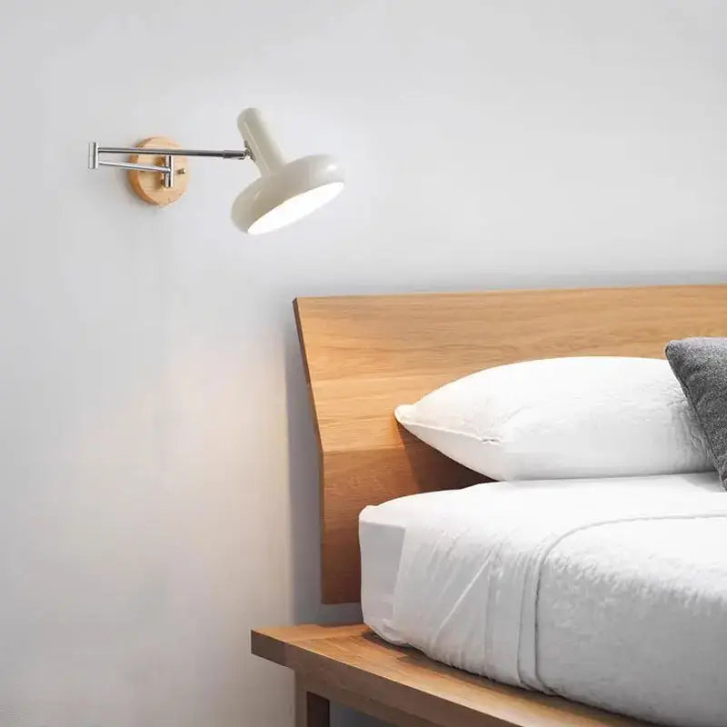 A sleek white wall lamp with a wooden base and cream rocker arm for decorbites cream rocker bedroom decor