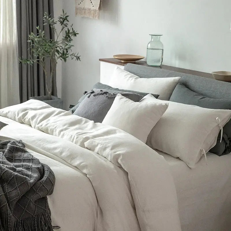 Vintage white and gray linen bedding set featuring neutral-toned linen bedding with soft textured pillows
