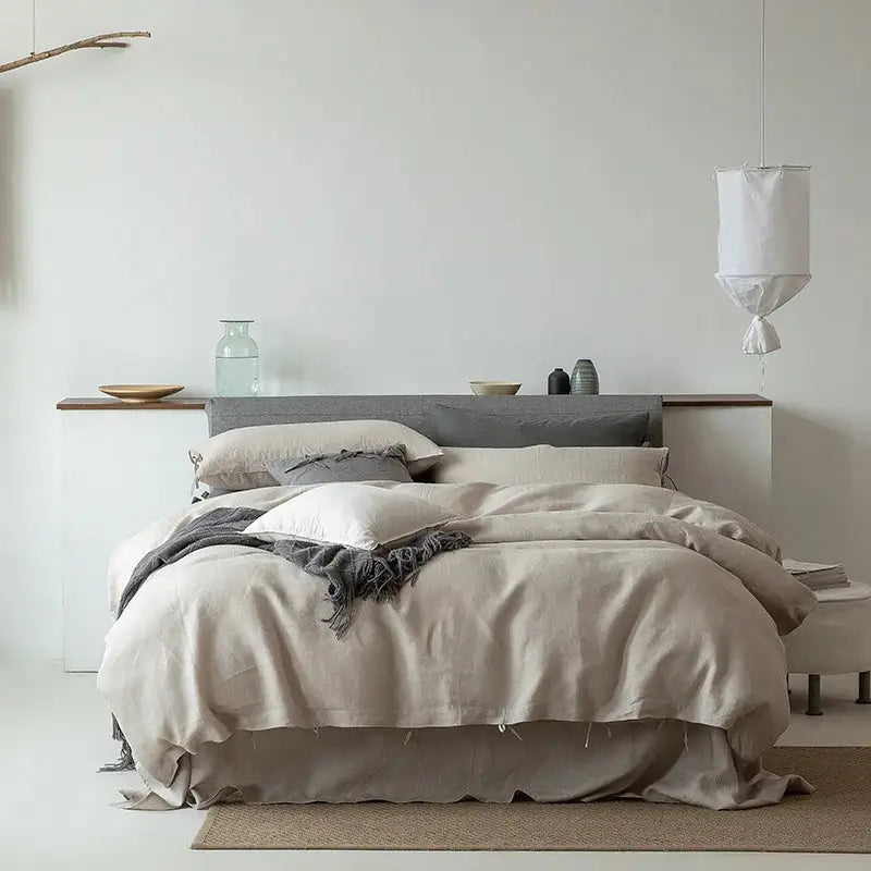 Beige linen bedding set with soft textured finish and subtle frayed edges in vintage white and gray style