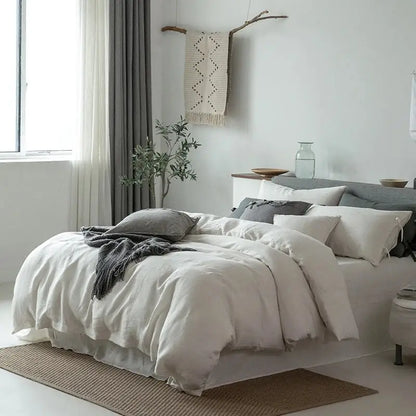 White linen bedding set with soft slightly wrinkled texture and matching pillowcases for bedroom use