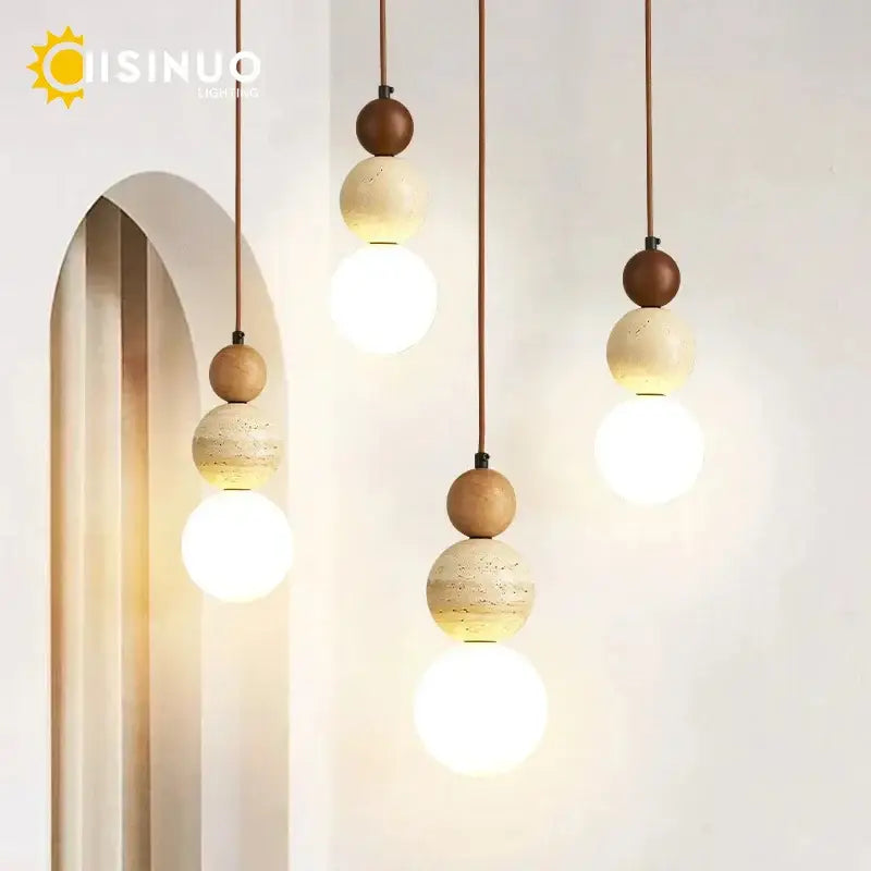 Modern pendant light with beige stone and warm brown wooden accent beads suspended by thin cords for dining room