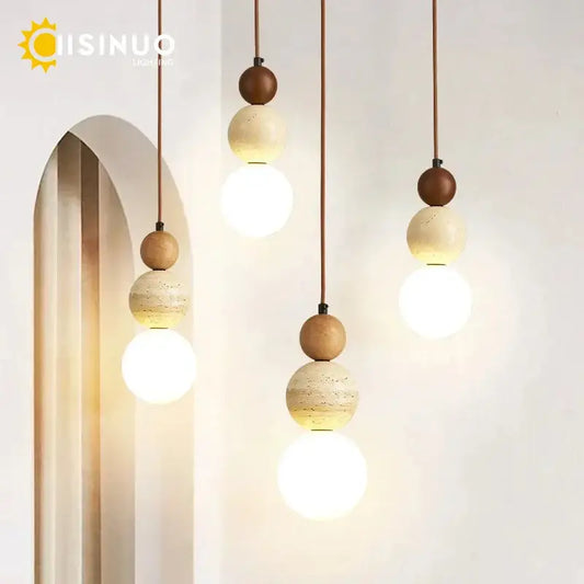 Modern pendant light with beige stone and warm brown wooden accent beads suspended by thin cords for dining room