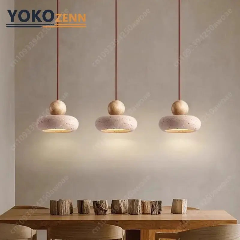 Three minimalist pendant lights with beige travertine stone shades 15cm x 11cm and wooden spheres for dining rooms