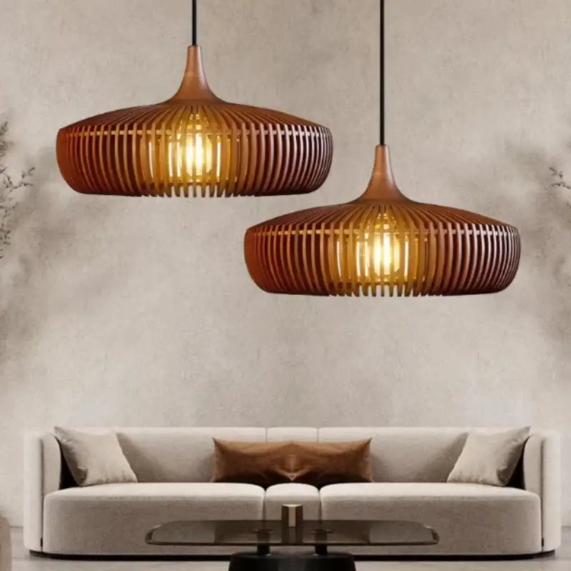 Two warm-toned brown ribbed wood pendant lights serve as a stylish light source above a modern sofa in living room space under square meters