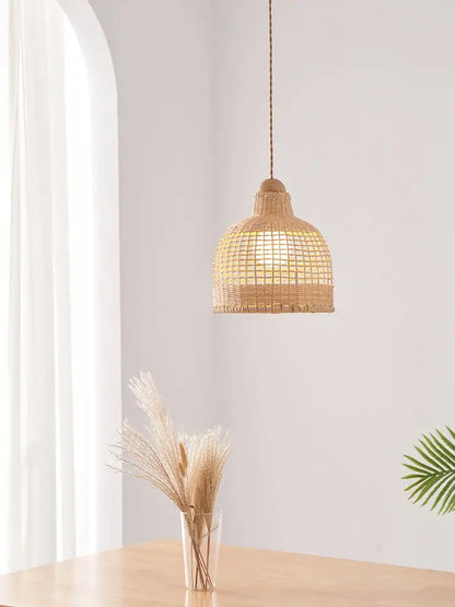 A warm-toned woven rattan decorbites bamboo pendant lamp with natural wood top for dining room island lighting
