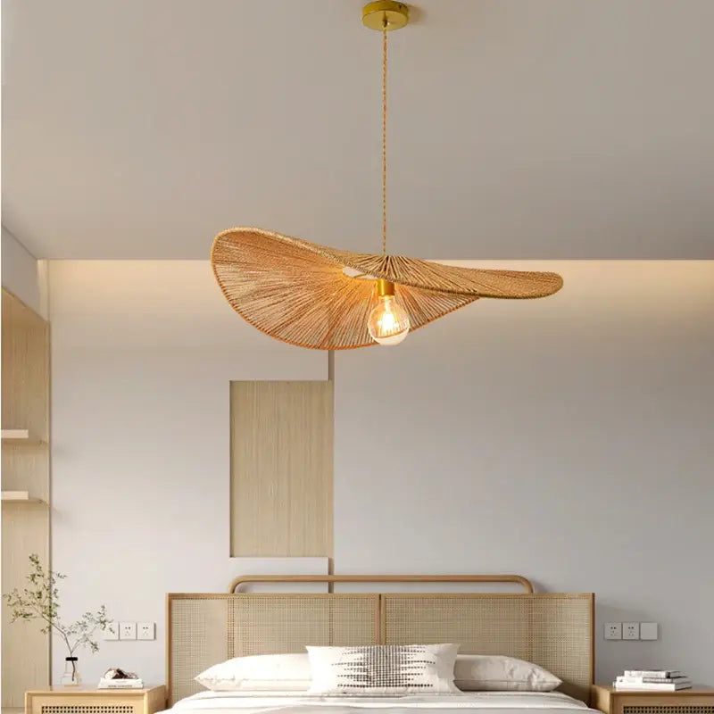 Golden-toned bamboo wabi sabi pendant light with woven leaf-shaped rattan design for dining room lighting
