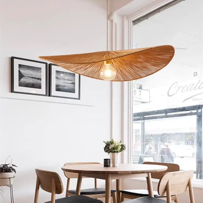 Warm-toned bamboo wabi sabi pendant lights with woven radial fan design and exposed bulb for dining room