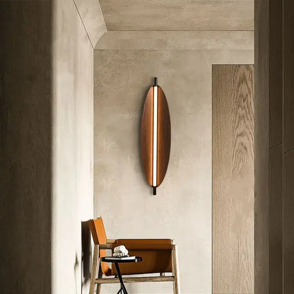 A sleek copper led wabi sabi wall sconce with a vertical light strip for a warm amber glow in dining room lighting