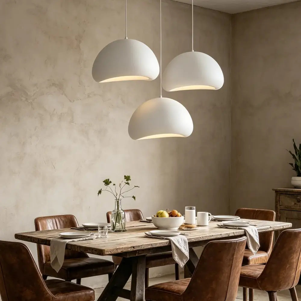 Three white dome-shaped pendant lights made of high-density polystyrene with led bulbs for dining room use