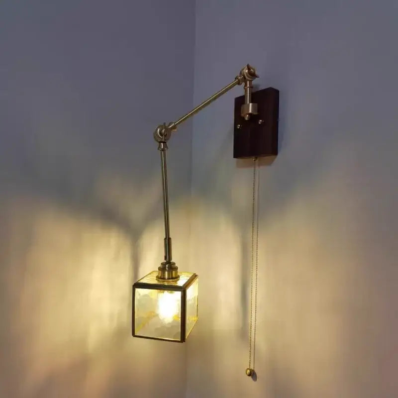 Brass-finished adjustable wall sconce with square cube glass led shade and dark walnut wood mounting plate decorbites cube glass