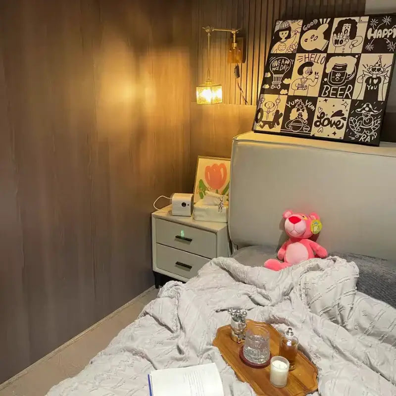 Pink plush stuffed bear sitting on bed near walnut and brass cube glass led wall sconce decorbites cube glass light