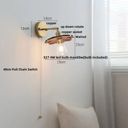 Walnut and brass wall sconce with pull chain switch featuring copper and walnut materials and vintage edison bulb