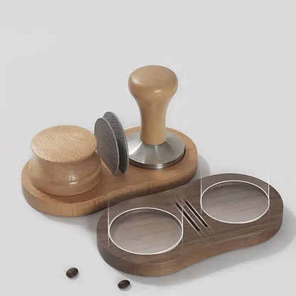 Wooden tamping station with light brown handle stainless steel espresso tamper and matching accessories on dark tray