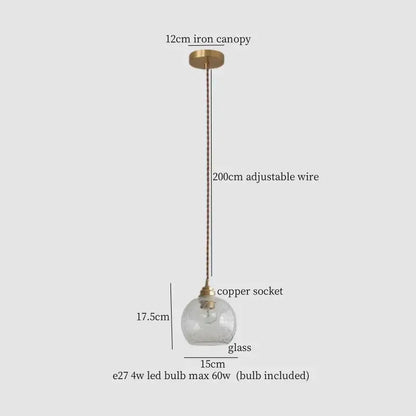 A clear glass globe pendant light with warm brass cracked glass led socket and iron canopy for kitchen dining room decorbites