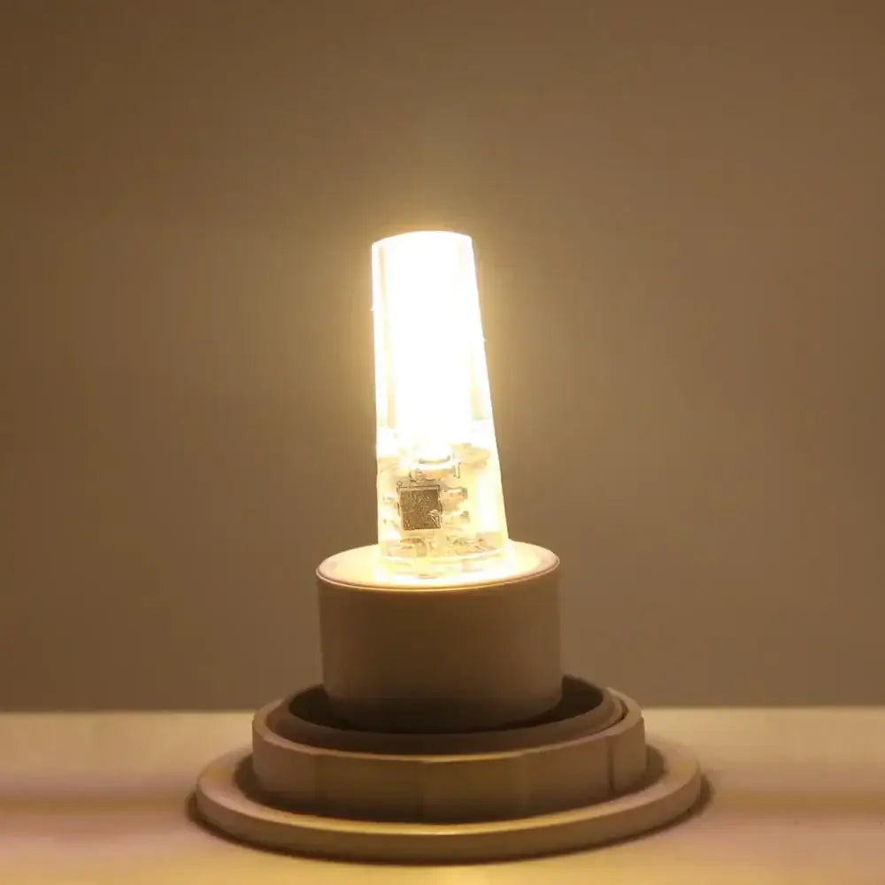 Warm yellow glass decorbites g4 cob led bulb with clear casing and visible internal circuitry for living room crystal light