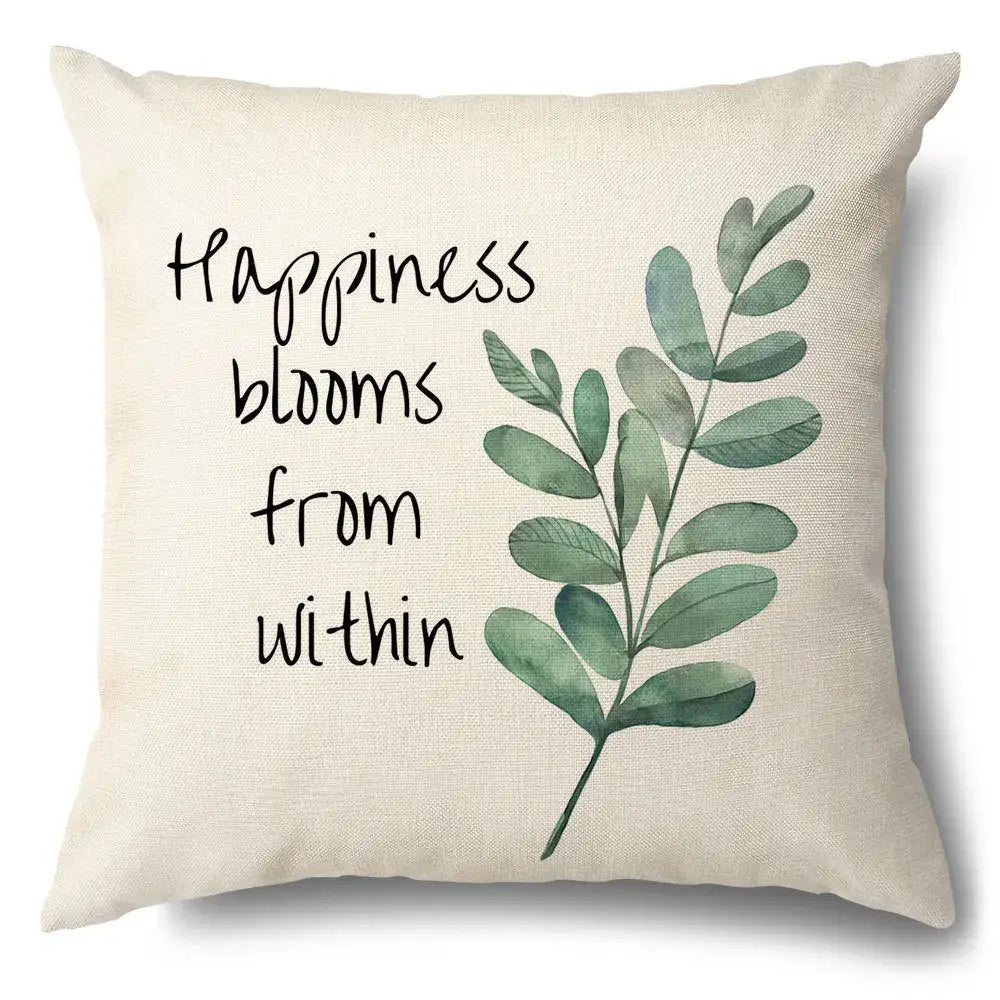 Beige linen pillow case with watercolor green leaves decorative design and happiness blooms from within script