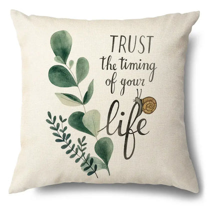 Beige linen pillow case with green leaves decorative watercolor design and snail featuring trust the timing phrase