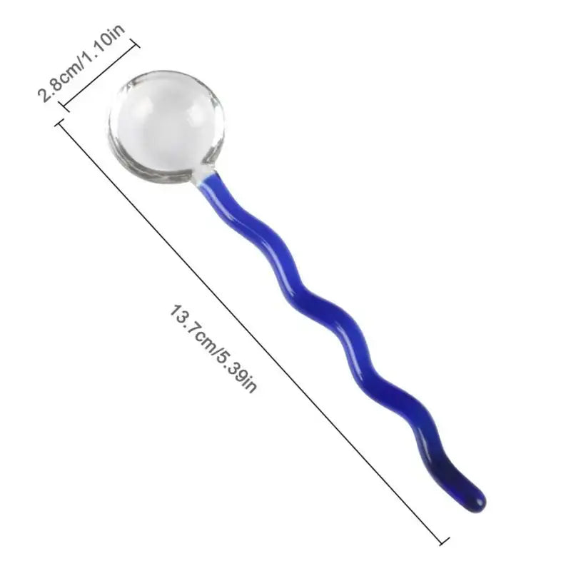 A clear glass sphere with a vibrant blue wavy-handled glass spoon coffee stirring rod for kitchen use