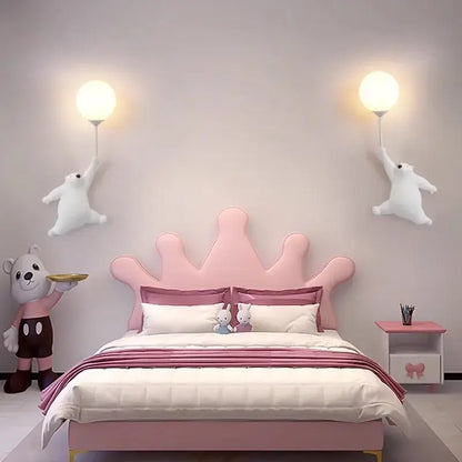 Pink crown-shaped upholstered headboard with matching bedding in bedroom featuring whimsical bear 3d moon wall lamp decorbites blue bear