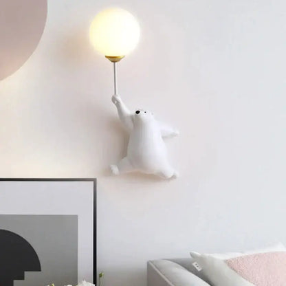 White polar bear wall lamp with spherical frosted glass shade and gold-toned stem for kids bedroom decor