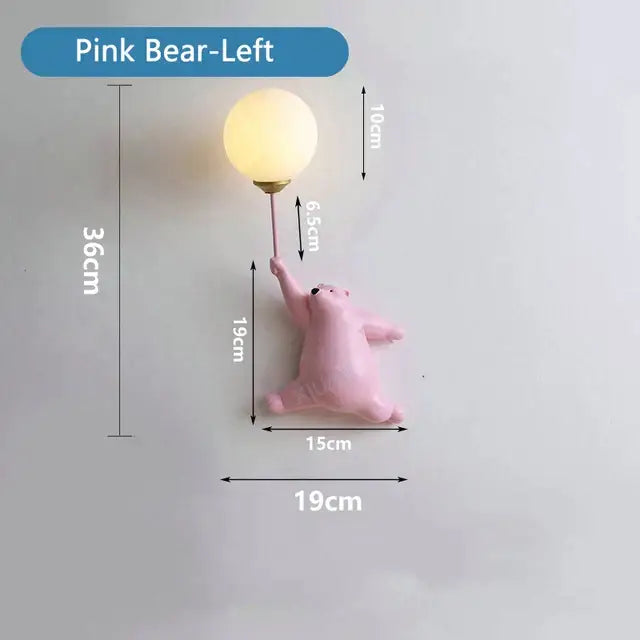 Whimsical blue pink and white bear wall lamp for kids bedroom featuring a pink bear wall lamp with warm round bulb held aloft